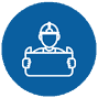 Icon of a person wearing a hard hat, holding a blueprint. The figure is outlined in white against a blue circular background, symbolizing construction or planning.