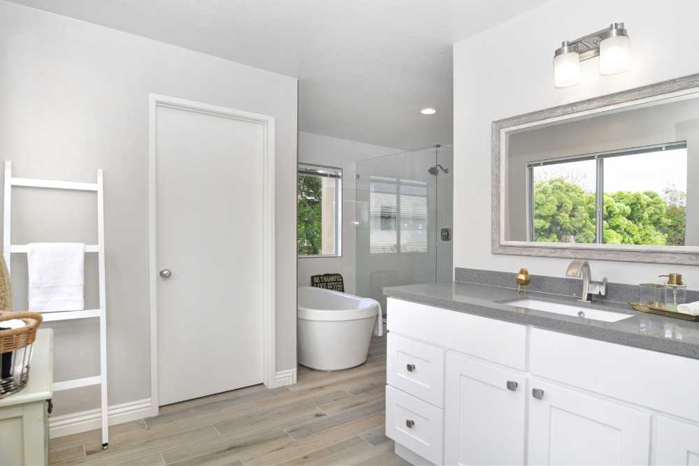 Stylish bathroom showcasing white cabinets against elegant grey walls, remodeled by Nativi Construction in Ventura County.