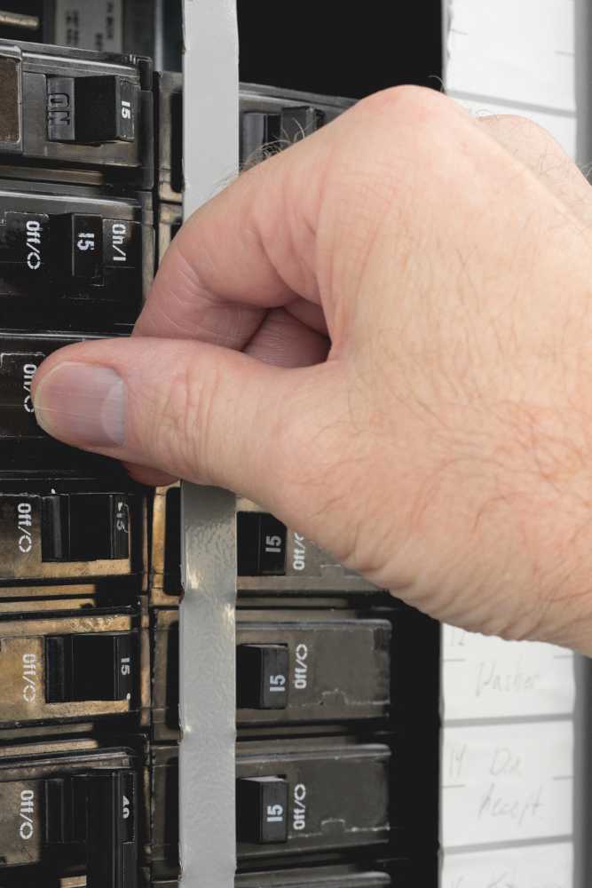 Contractor performing repairs on an electrical outlet in a residential setting in Ventura County, serviced by Nativi Construction.